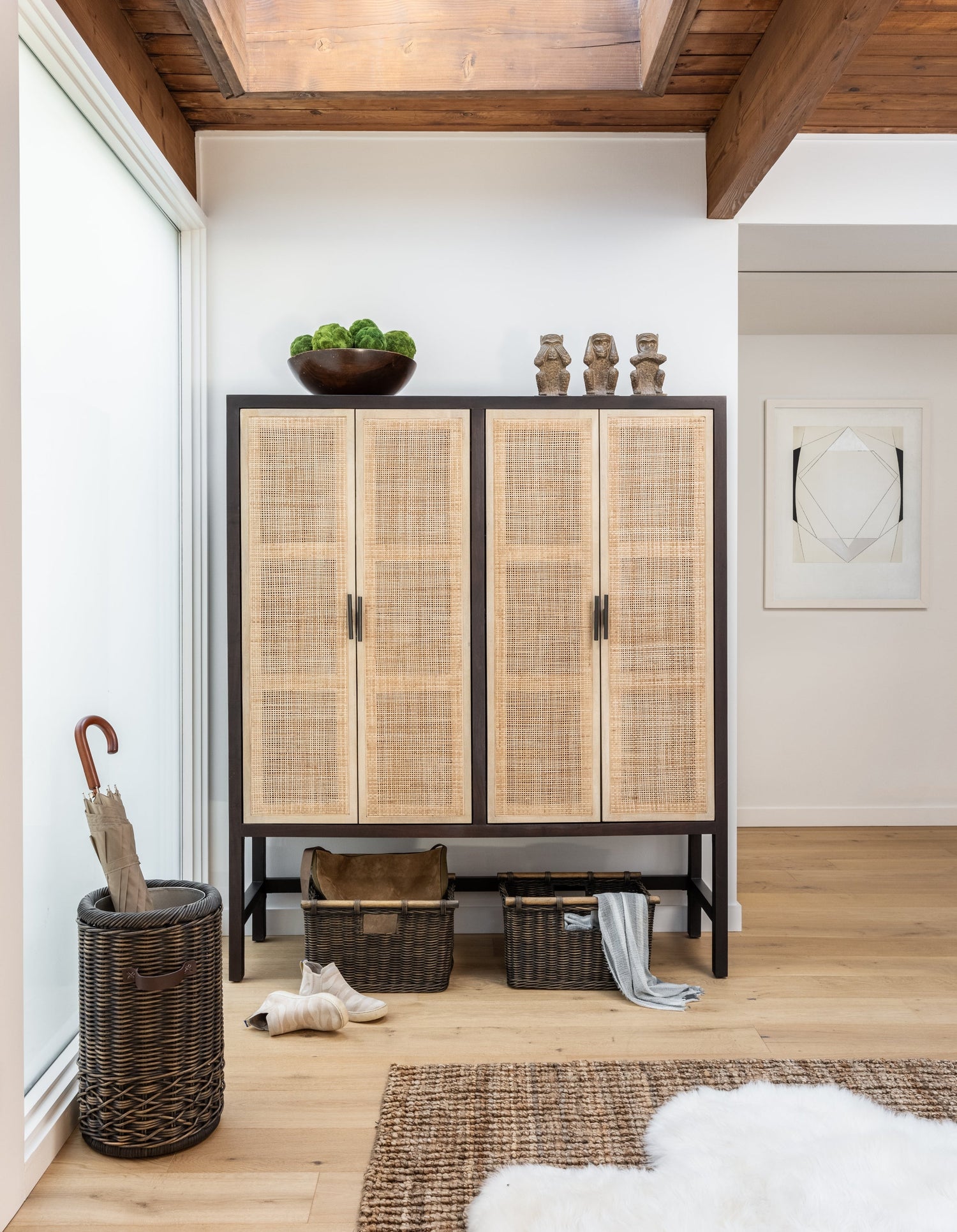 Heavy-duty wicker storage baskets organizing tools and household items on garage shelves.
