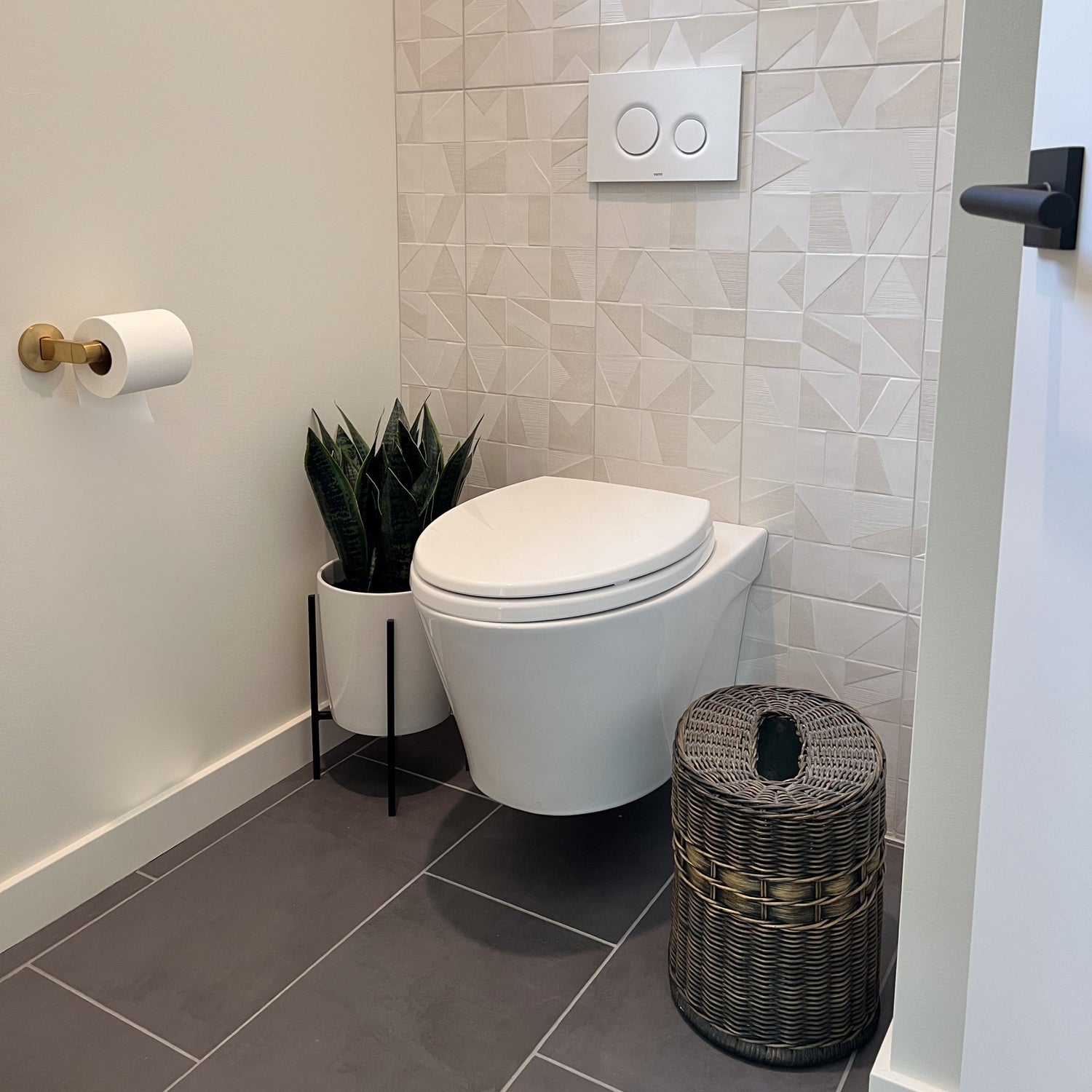 Decorative wicker trash basket styled in a modern home interior.
