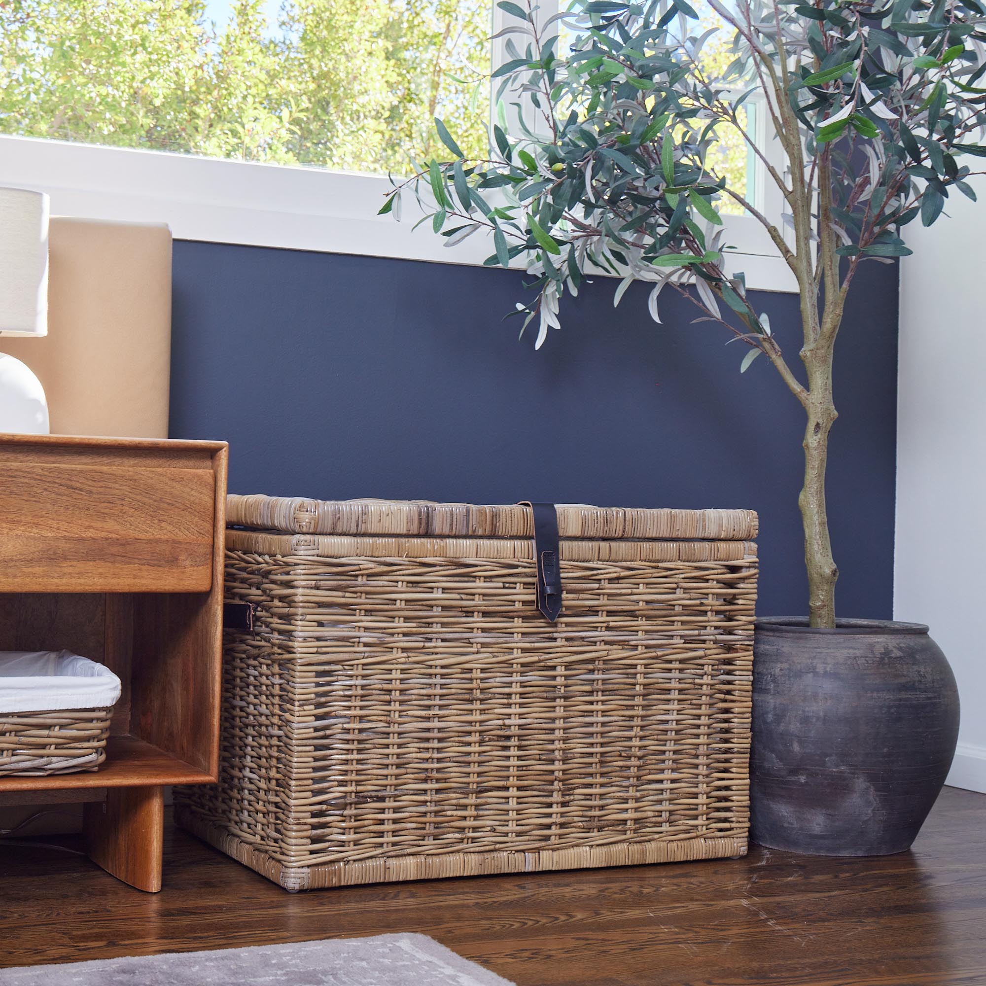 Deep Kubu Wicker Storage Trunk in Serene Grey, shown in bedroom below window | The Basket Lady