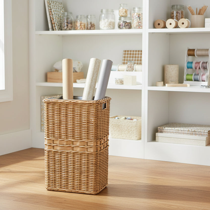 Large Wicker Waste Basket in Sandstone used in a craft room to hold rolls of wrapping paper