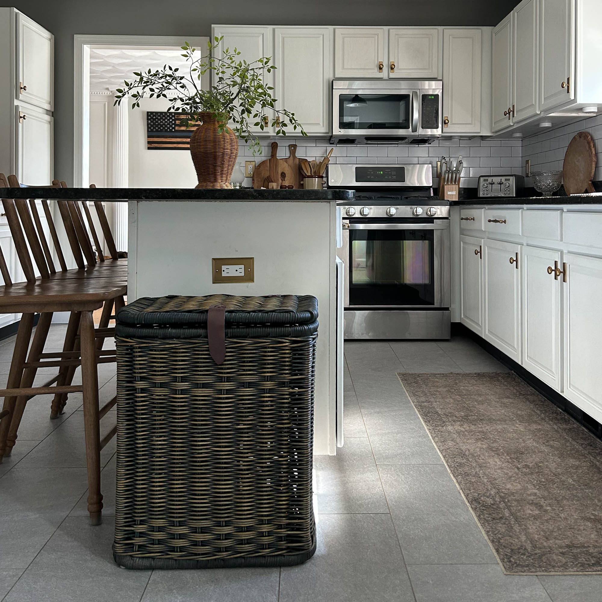 Wicker Kitchen Trash Basket with Metal Liner in Antique Walnut Brown at white cabinet island | photo by @s.maz.home