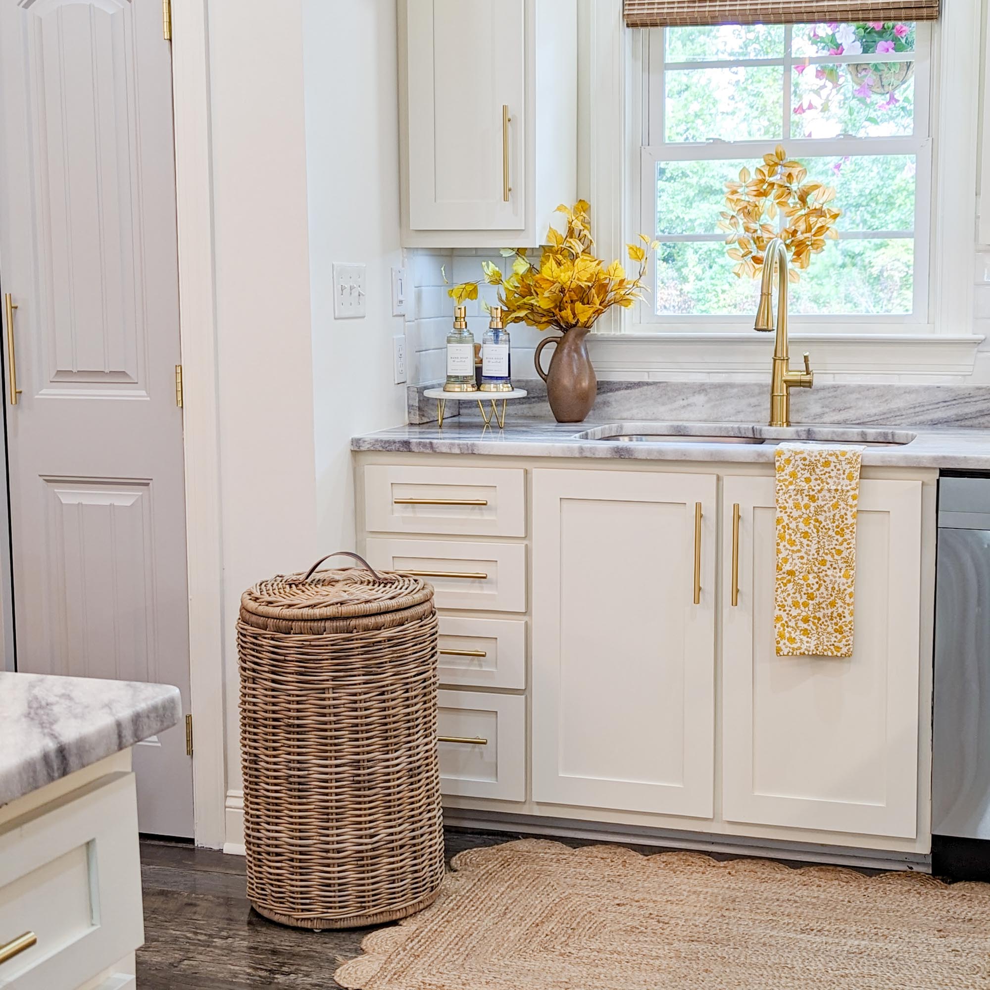 Tall Kubu Wicker Kitchen Trash Basket shown in white kitchen styled by Bridgeway Designs | The Basket Lady