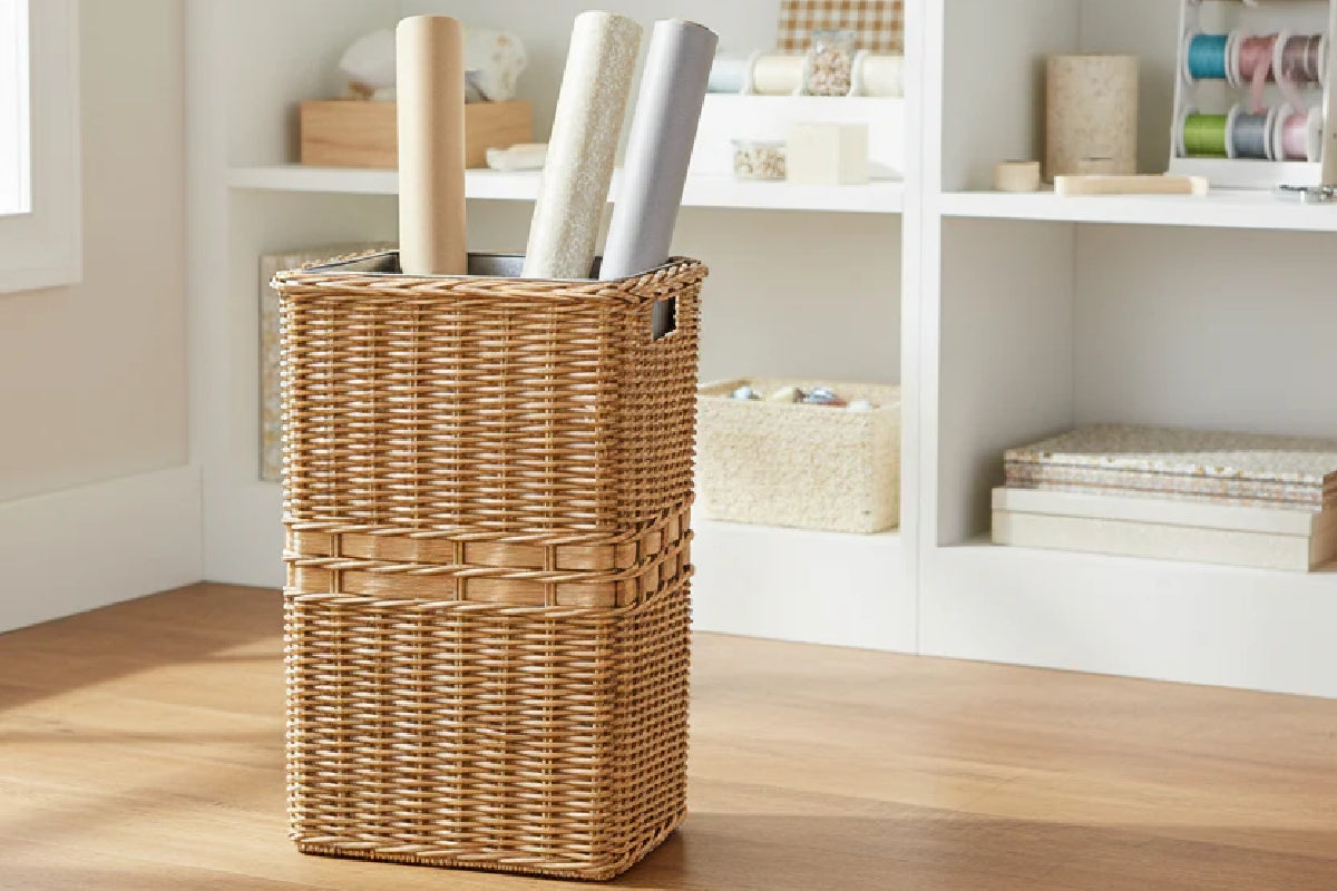 Craft room organized with wicker baskets storing art supplies and materials.