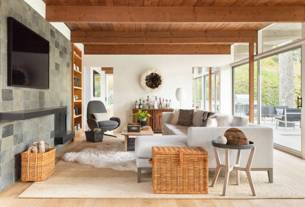 Decorative wicker baskets used to hide clutter in a neatly organized living room.