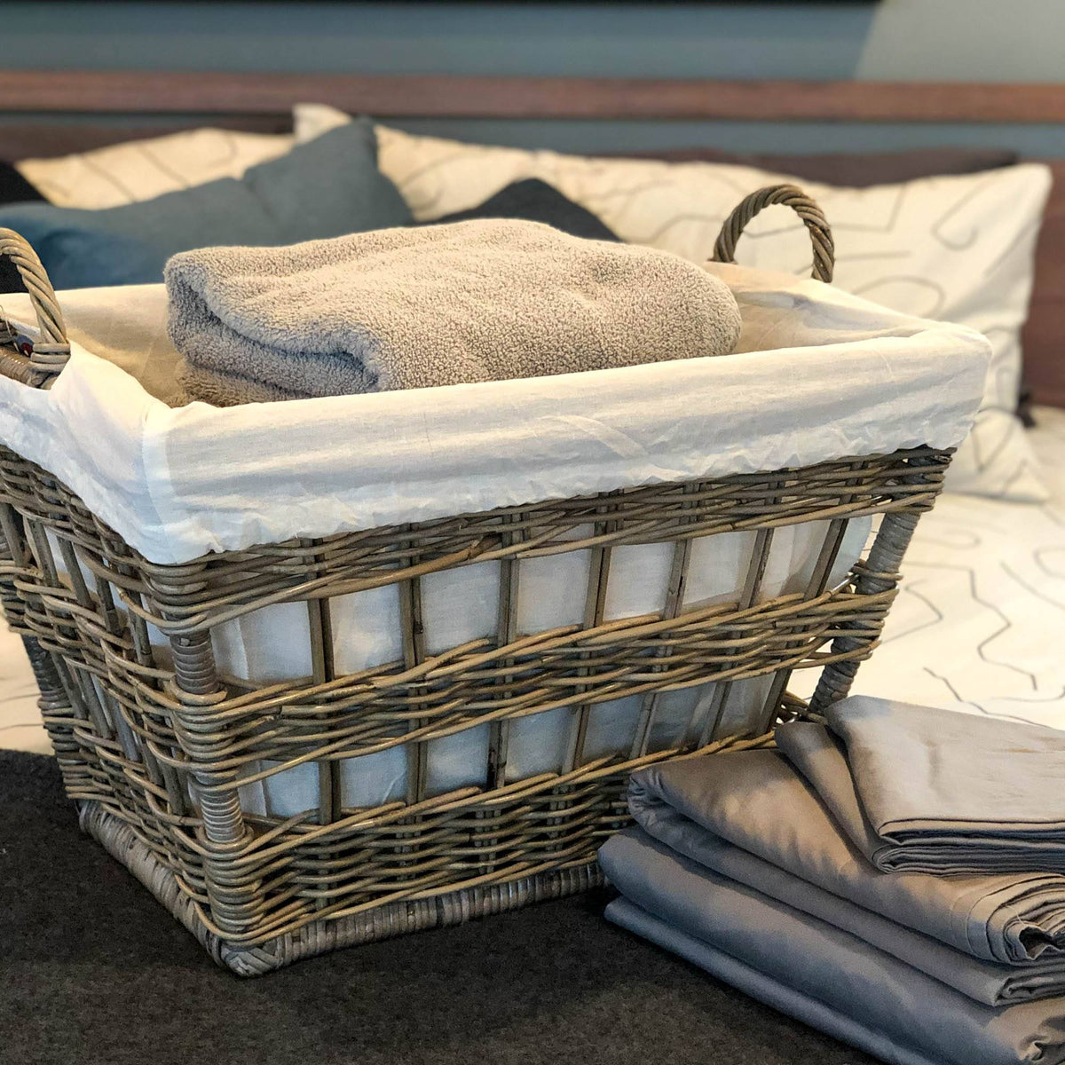 Handwoven wicker baskets with handles used for portable storage of blankets and household items