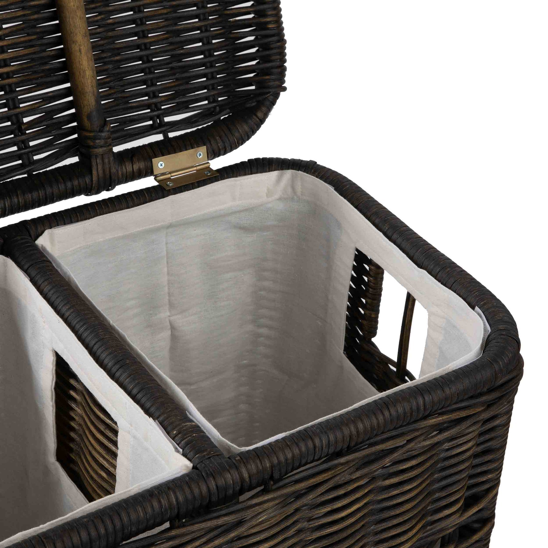 Close up of a 2 compartment wicker laundry hamper. 